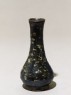 Black ware vase with yellow splashes (oblique)