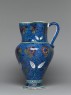Jug with flowers against a fish-scale background (side)