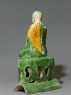 Roof ridge tile in the form of a seated Buddhist figure (side)