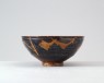 Black ware bowl with brown splashes (oblique)