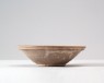 White ware bowl with rocks emerging from waves (oblique)