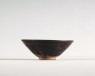 Black ware tea bowl with brown streaks (oblique)