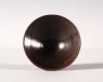 Black ware tea bowl with brown streaks (oblique)