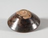 Black ware tea bowl with brown streaks (oblique)