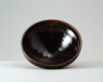Black ware bowl with russet iron splashes (oblique)