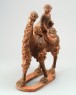 Figure of a camel carrying a young girl (oblique)