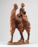 Figure of a camel carrying a young girl (oblique)