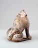 Figure of a lion scratching its head (oblique)