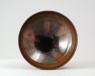 Black ware bowl with russet iron splashes (oblique)